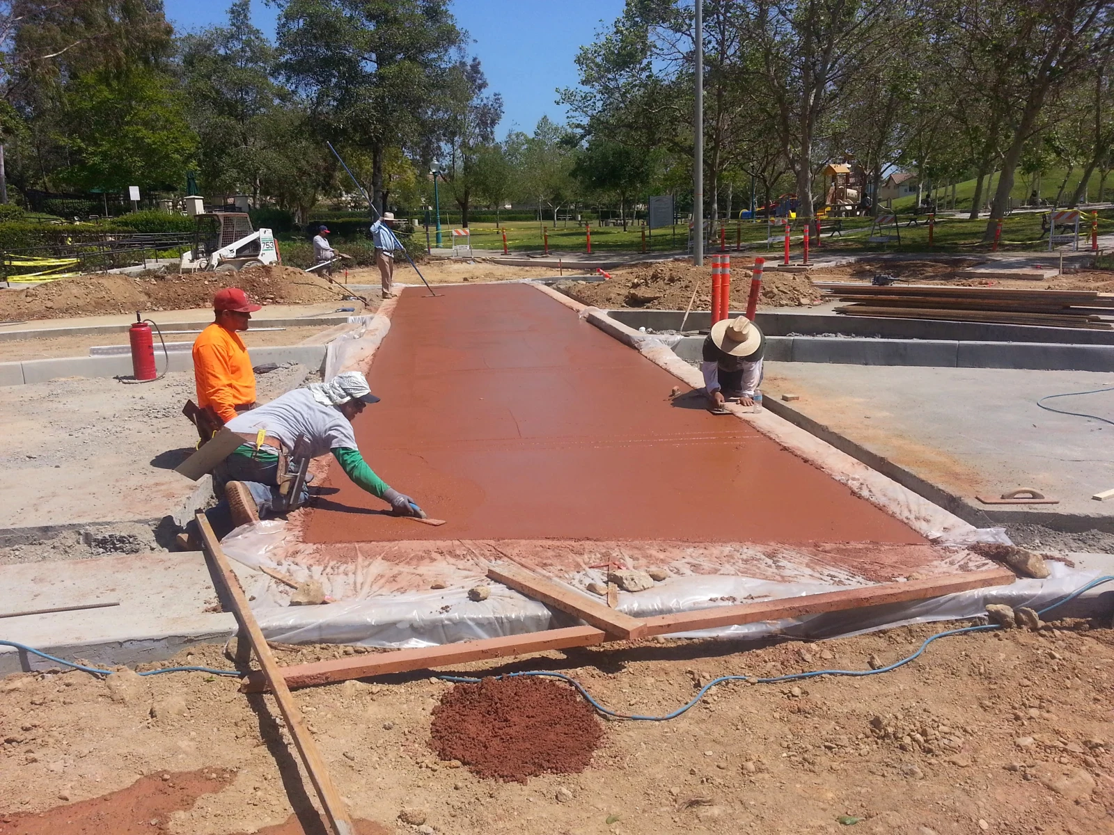 Crew finishing a concrete walkway